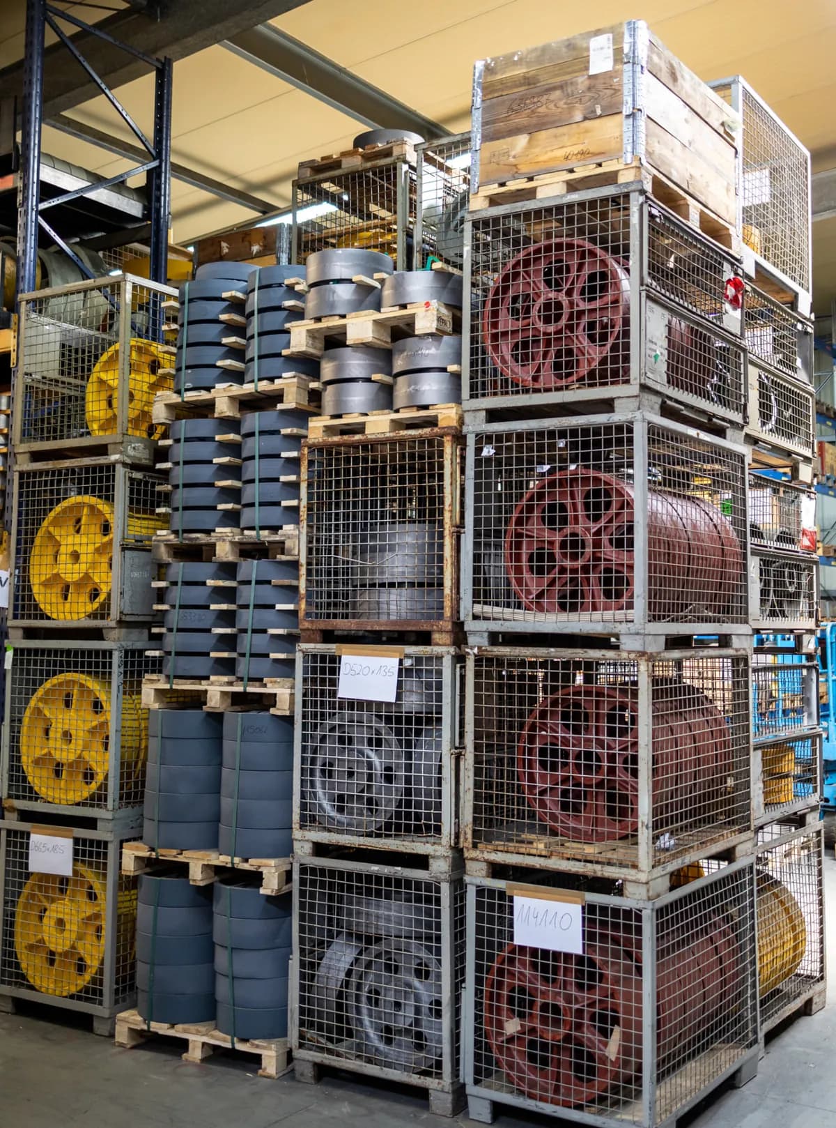 Unmachined cast elevator sheaves, coated and batched in a stillage in the FUKA warehouse