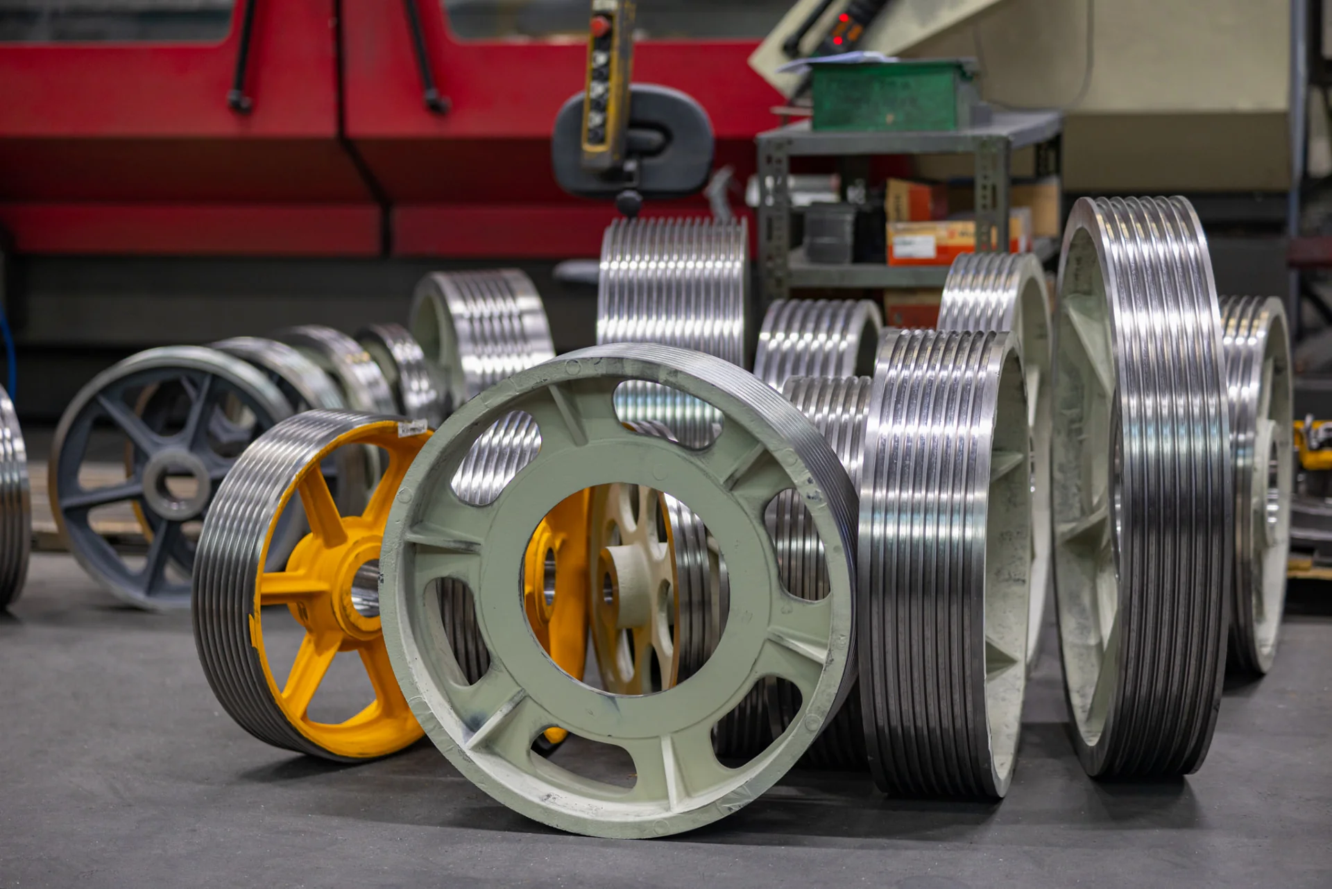 Finished elevator traction sheaves standing side by side on the FUKA shop floor in Cologne