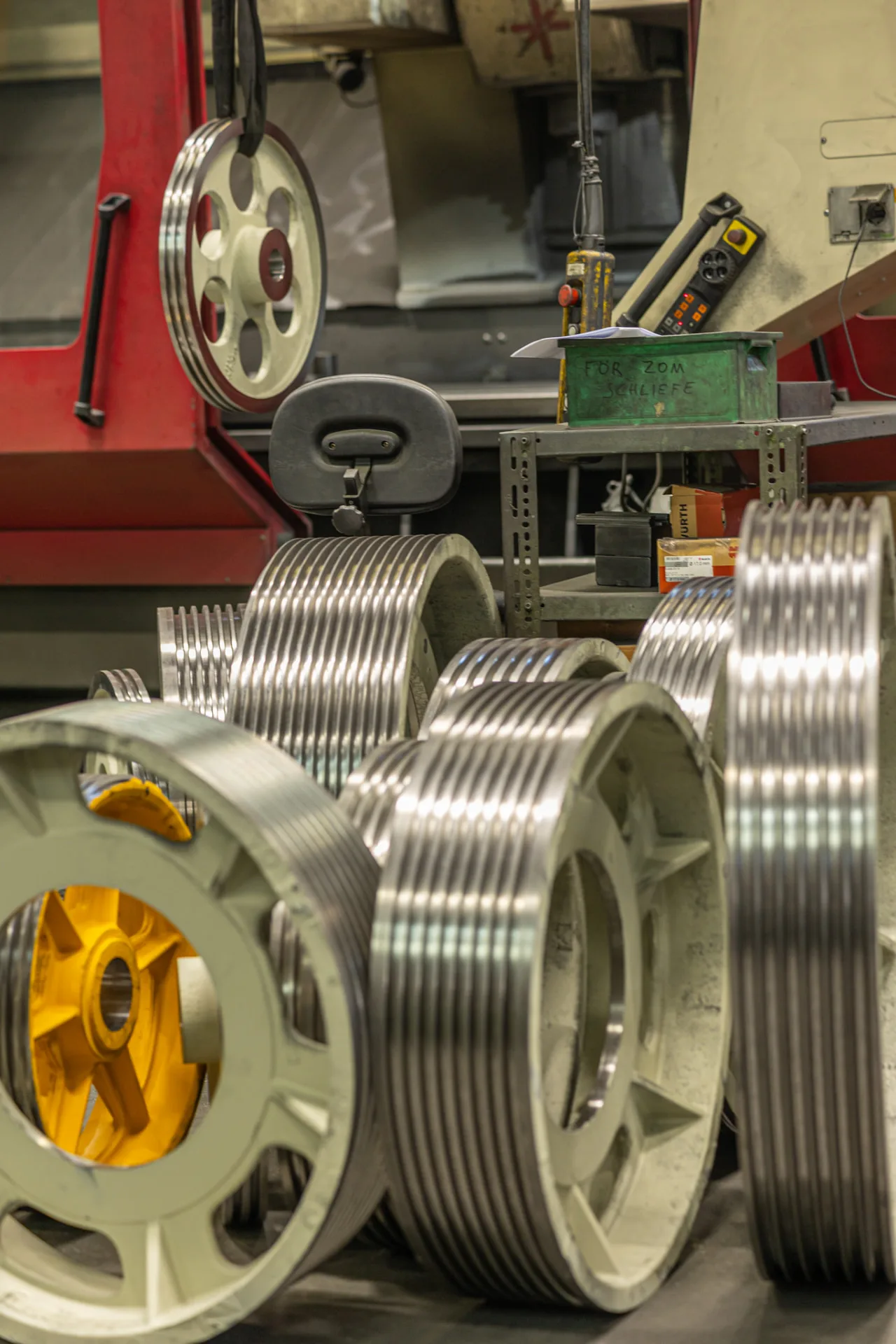 Machined elevator traction sheaves of several diameters standing in the FUKA workshop in Cologne